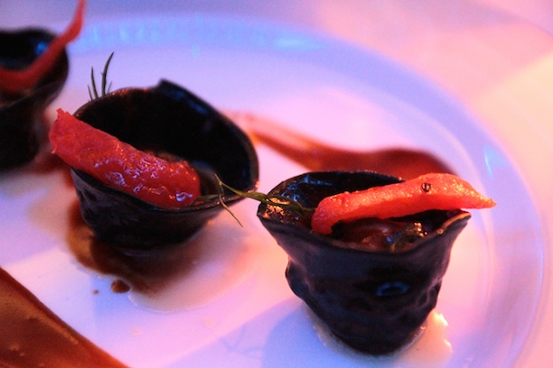 Mediterranean prawns in squid ink ravioli with lobster bisque reduction and basil