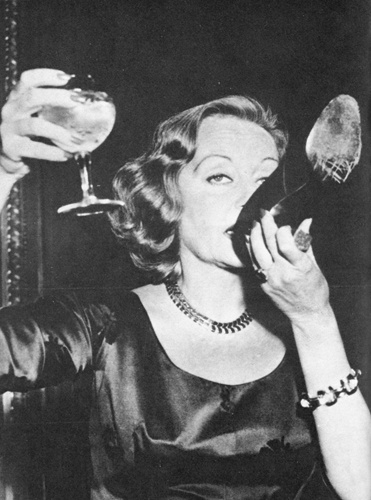 Tallula Bankhead drinking champagne out of her shoe at The Ritz 1951