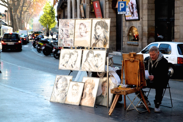A man paints portraits on La Ramblas